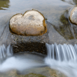 heart shaped rock in stream