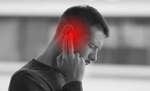 Man suffering from ringing ears / tinnitus